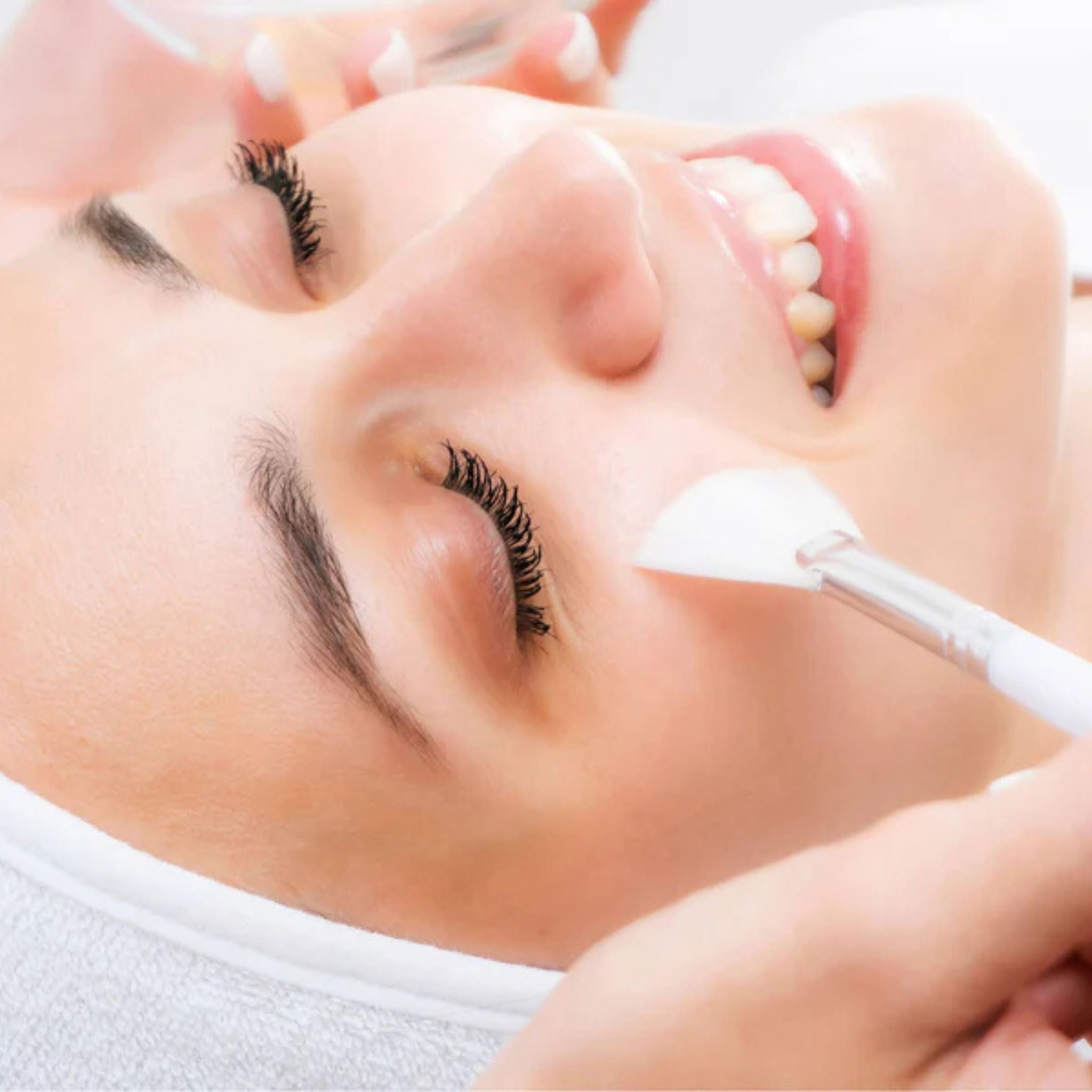 Chemical peel on models face applied with a fanned brush.