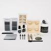 Lash products with wipes, brushes, false eyes on a white backdrop. 